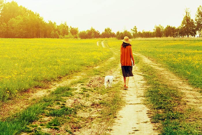 girl-walking-with-her-pup
