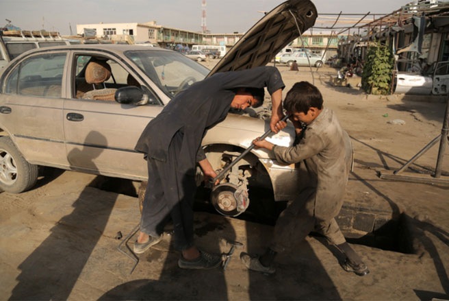 Những cậu bé người Afghanistan làm việc trong một xưởng cơ khí ở Ghanzi hồi đầu tháng 6. Hàng chục nghìn trẻ em ở Afghanistan đang phải làm việc để kiếm sống - Tin: WSJ/Ảnh: AFP/Getty.