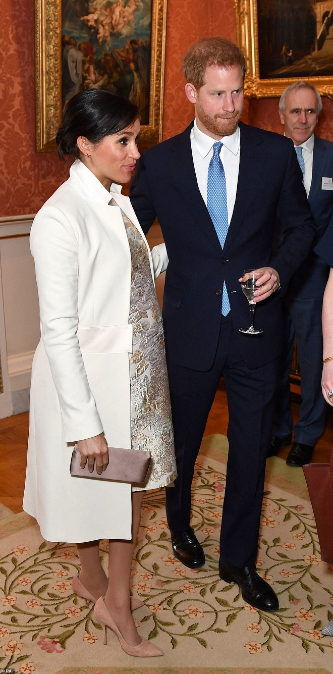 Vợ Hoàng tử Harry chọn đầm họa tiết hoa có độ ôm sát vừa đủ kết hợp với áo khoác trắng đến từ hương hiệu Amanda Wakelay có giá 895 bảng Anh.