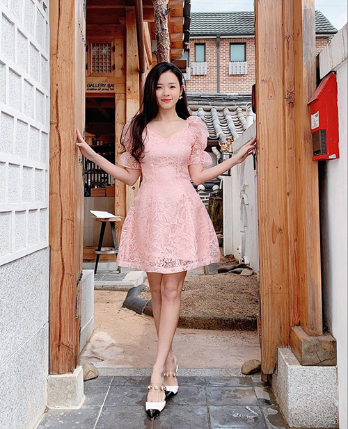 Midu trông càng trẻ xinh khi diện váy xòe hồng pastel trên đường phố Seoul.    