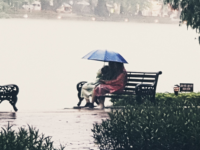 Hình ảnh cặp đôi nắm tay nhau dưới mưa suốt cả tiếng đồng hồ.