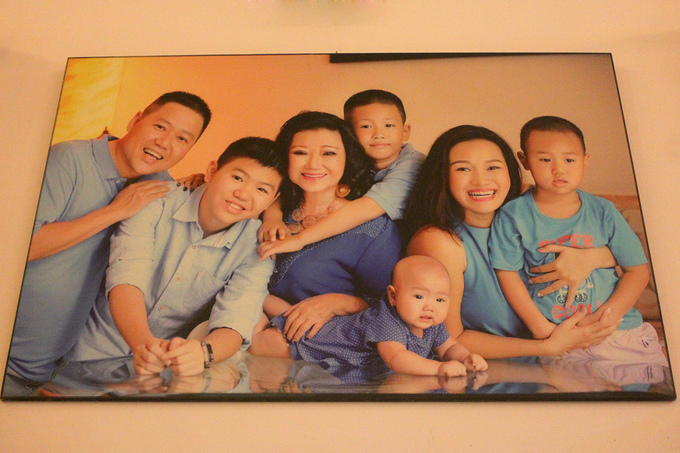 Nghệ sĩ treo bức ảnh chân dung đại gia đình ở vị trí trang trọng trong nhà. 