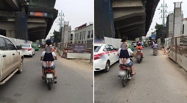 Bé gái không đội mũ bảo hiểm đứng lên yên xe máy.