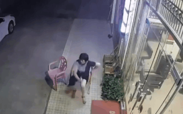 Người phụ nữ ngồi trước cửa nhà bị ô tô đâm trúng.