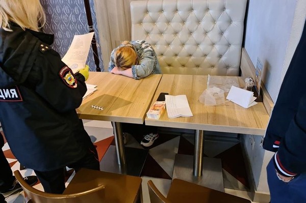 Bà mẹ trẻ gục mặt xuống bàn khi bị phát hiện ra bên mua là nhân viên điều tra (Ảnh: Social media)  