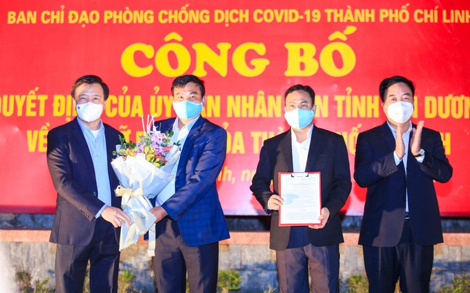 Bí thư Tỉnh ủy tỉnh Hải Dương Phạm Xuân Thăng tặng hoa và trao quyết định dỡ bỏ lệnh cách ly xã hội (Ảnh: Người lao động)