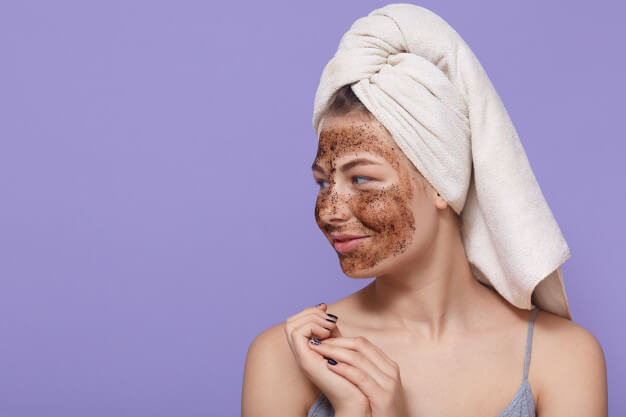 portrait-female-model-applies-chocolate-mask-face-has-positive-expression-looks-aside_176532-10644