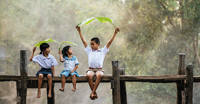 asian-boy-little-girls-sitting-wooden-bridge-joyful-playing-with-banana-leaves-head-smile-laughting-with-funny-together-copy-space-rural-scene-style-concept-1150-55885-700x366