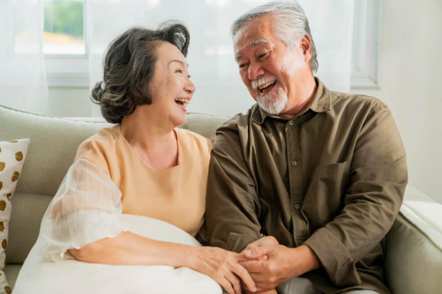 1-old-senior-asian-retired-age-marry-couple-wellness-lifesstyle-together-homeold-people-laugh-smile-together-with-love-bonding-sofa-living-room-home-interior-background-1