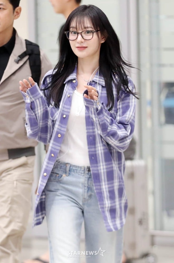 Kim Ji Won diện bộ outfit gồm quần jeans mix với áo thun trắng, khoác thêm áo sơ mi flannel bên ngoài đơn giản.