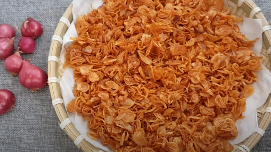 Fried shallots cooling on a plate