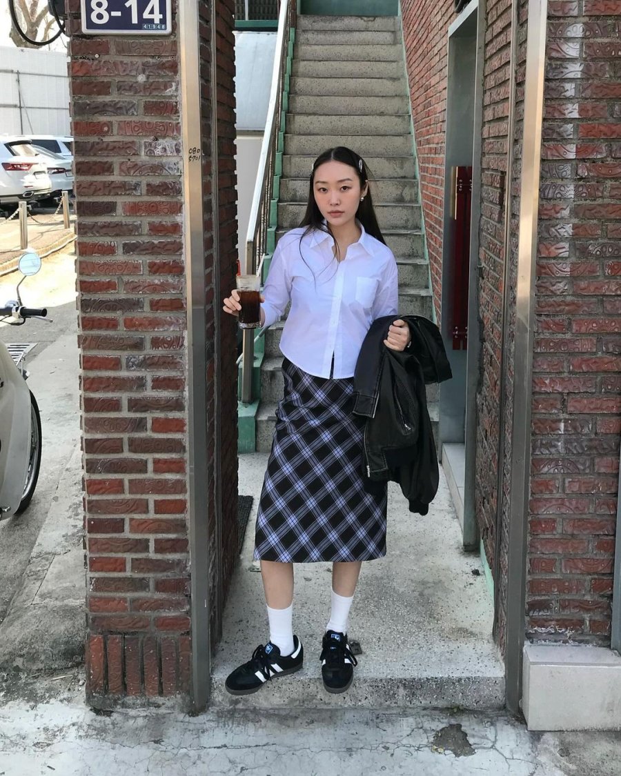 Woman in a shirt and midi skirt