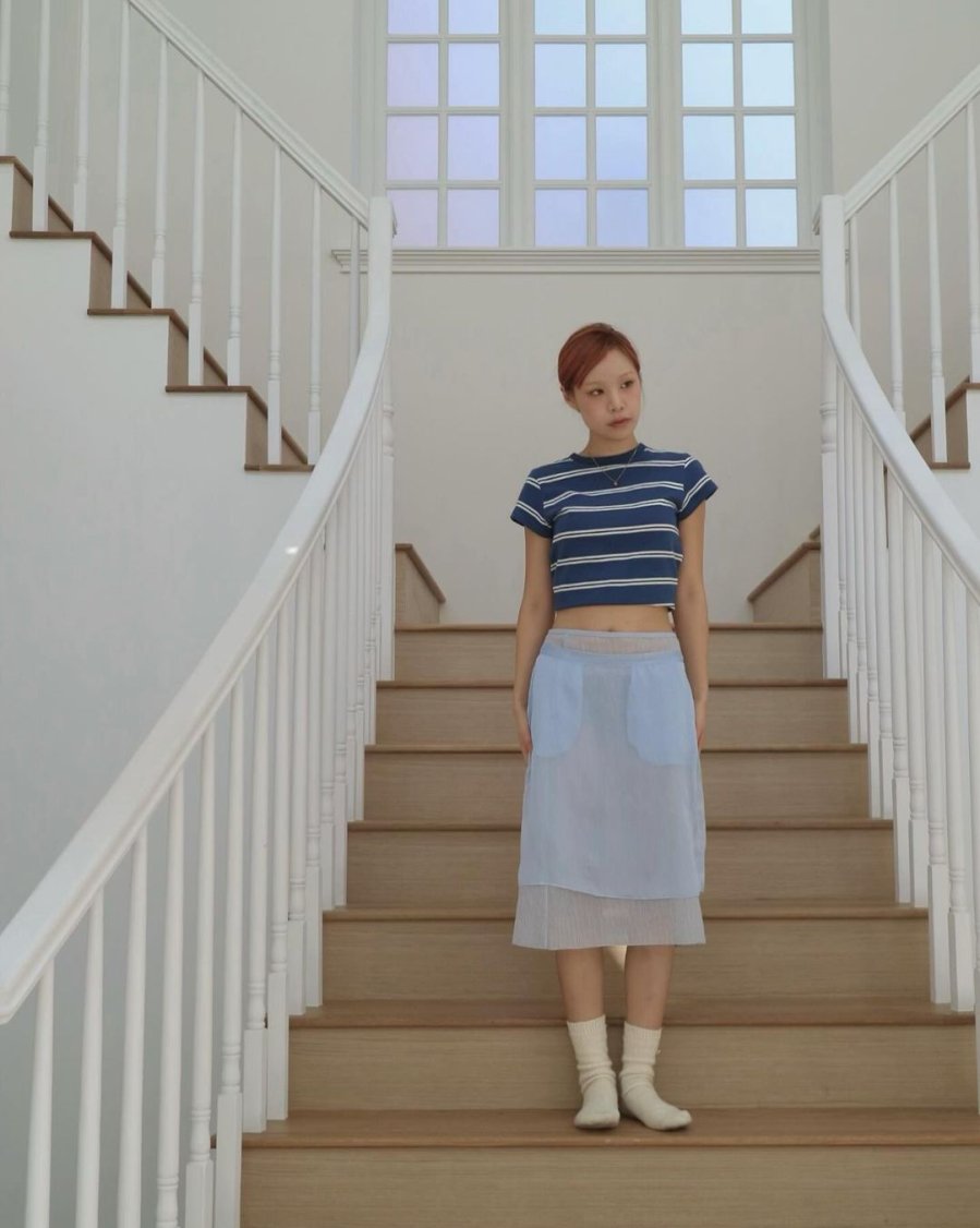 Woman in a crop top and midi skirt