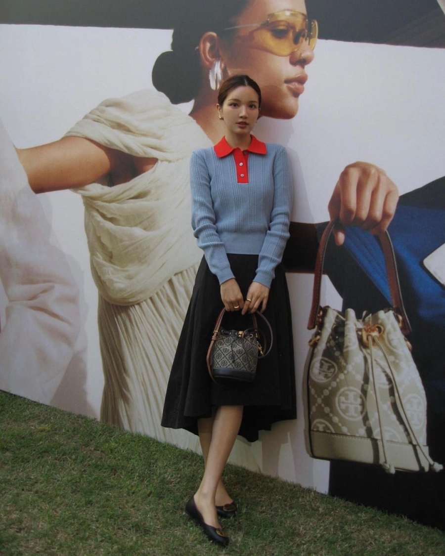 Woman in a sweater and midi skirt