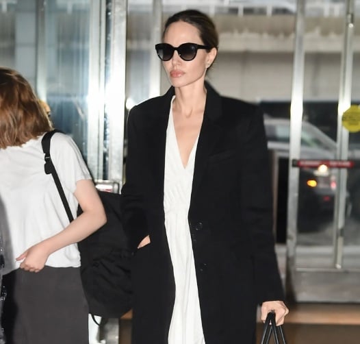 Angelina Jolie gợi ý set đồ đơn giản nhưng vô cùng cuốn hút bao gồm váy trắng kết hợp với áo khoác đen, dáng dài.