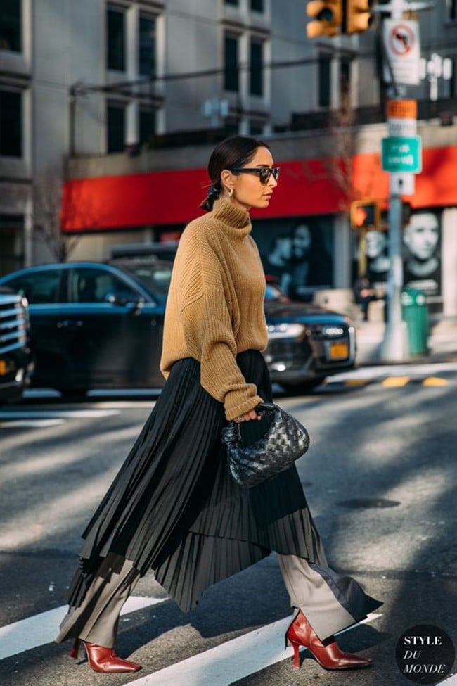 Turtlenecks and pleated skirts create a figure-flattering and elegant ensemble