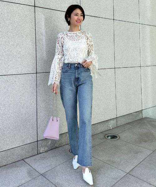 Chi tiết ren mềm mại được cân bằng bằng quần denim đứng phom, giúp bộ trang phục bớt cầu kỳ và dễ mặc hơn.