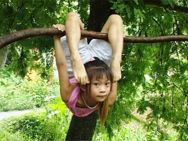 “Thần đồng” uốn dẻo tí hon Võ Ngọc Thu Thảo với màn biểu diễn độc đáo treo người trên cây bằng hai chân.  