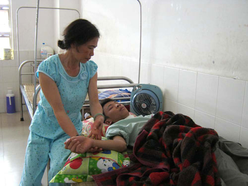 Chị Nguyễn Thị Ngọc Thủy (mẹ Lâm) đang chăm sóc cho Đặng Hắc Lâm tại bệnh viện.