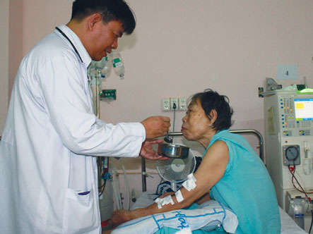 Bác sĩ Thắng chăm sóc mẹ trên giường bệnh (nguồn: SGTT)