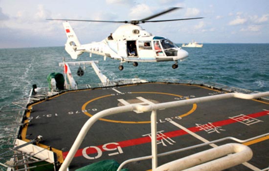 Hình ảnh một chiếc trực thăng quan sát hạ cánh trên tầu hải giám