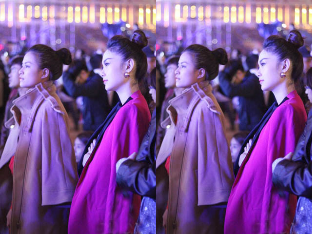 Hai người đẹp chăm chú xem các ngôi sao Hàn Quốc trình diễn.