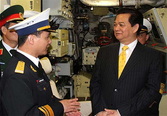 Thủ tướng Nguyễn Tấn Dũng chăm chú nghe thuyền trưởng tàu ngầm Hà Nội, Thiếu tá Nguyễn Văn Quán, báo cáo giới thiệu về tàu.