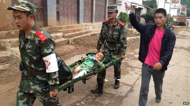 Binh sĩ Trung Quốc khiêng một đứa bé bị thương.