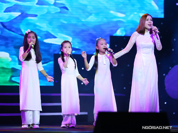 Lưu Hương Giang đưa 3 bé Nhã Thy, Hà Trang và Quỳnh Anh trong đội The Voice Kids lên sân khấu cùng hát 'Mùa xuân làng lúa làng hoa'.