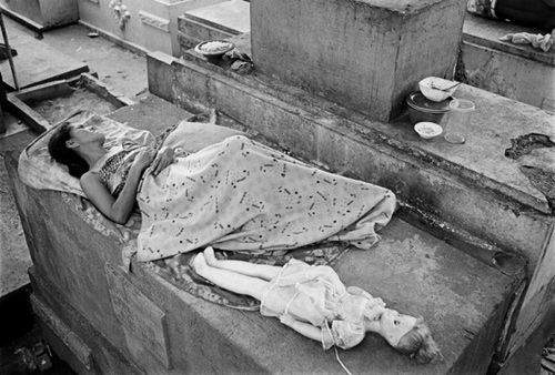 Người phụ nữ trải chiếu nằm ngủ trên lăng mộ
