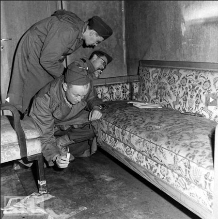 Trong ảnh là phóng viên chiến tranh dùng nến soi những dấu vết còn sót lại trên chiếc ghế trường kỷ nhuốm máu của Hitler. Trùm phát xít đã dùng súng tự sát ngay trong hầm ngầm này.