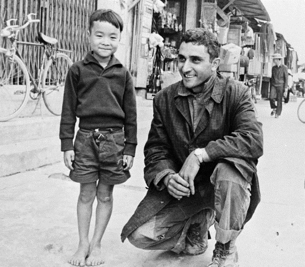 Phóng viên George Esper của hãng AP chụp hình cùng một bé trai Việt Nam tại tỉnh Quảng Ngãi, ngày 1/1/1966. Ảnh: AP