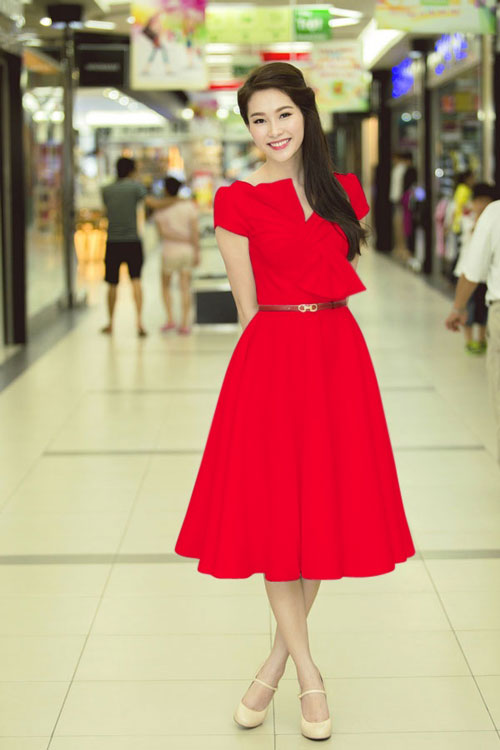 Tạo ấn tượng với kiểu dáng đơn giản mà trẻ trung, chiếc đầm đỏ Hoa hậu Thu Thảo lựa chọn có thiết kế cổ xẻ cách điệu với chiếc nơ to xinh xắn. Tay ngắn trẻ trung, vòng eo thon gọn cùng chân đầm xòe duyên dáng bồng bềnh, mang lại nét dịu dàng đáng yêu.