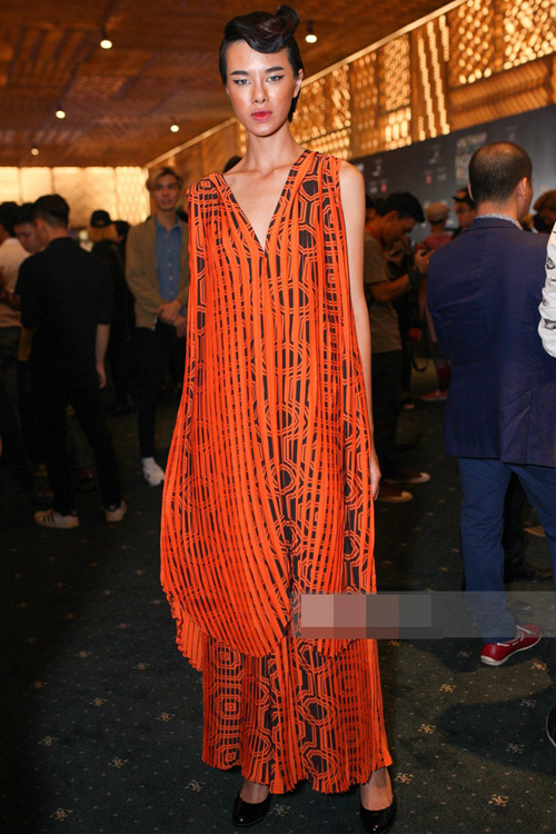 Triệu Hà chọn cho mình chiếc đầm xếp pleat màu cam nổi bật của thương hiệu I Hate Fashion.