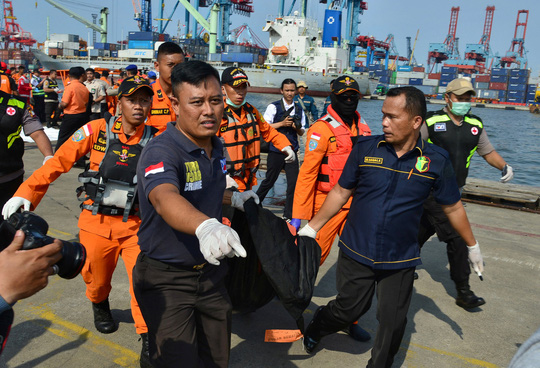 Lực lượng cứu hộ khiêng túi đựng thi thể hành khách từ chuyến bay gặp nạn hôm 29-10. Ảnh: REUTERS