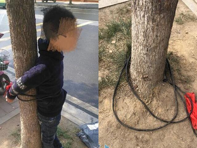 Cậu bé 9 tuổi bị trói chặt vào gốc cây trước cổng trường tiểu học ở thành phố Tương Dương, tỉnh Hồ Bắc, Trung Quốc