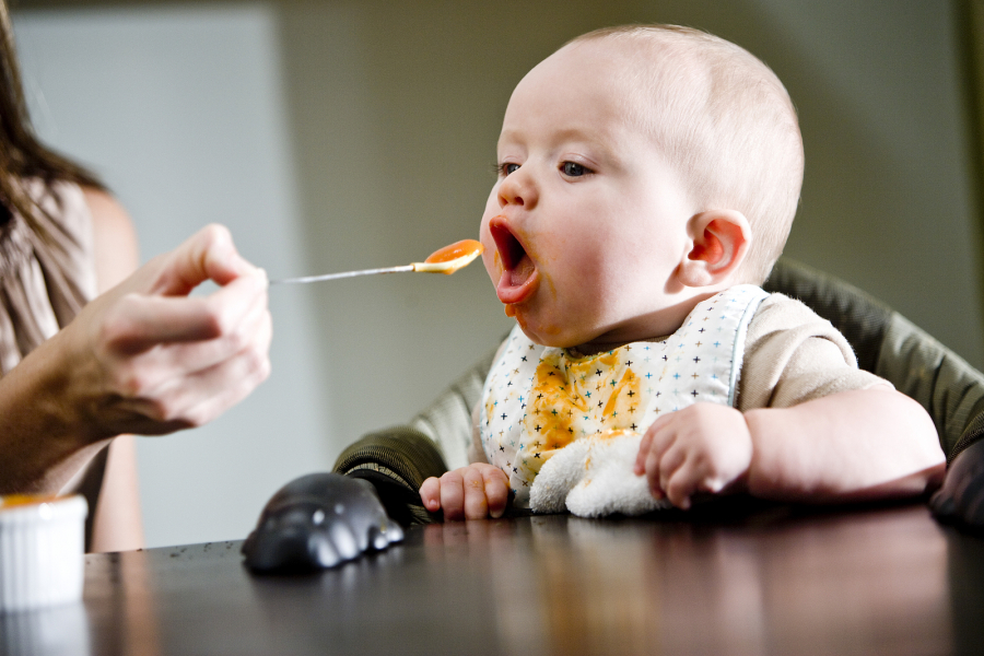 bigstock-Six-month-old-baby-eating-soli-27594302