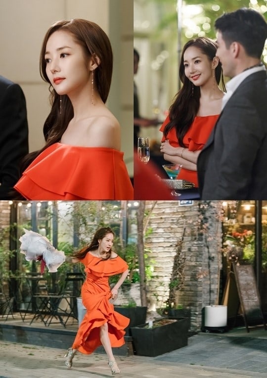 Tại buổi tiệc xa hoa, thư ký Kim rũ bỏ bộ cánh công sở quen thuộc. Cô nàng khoác lên mình chiếc váy trễ vai ôm sát màu cam, sánh bước bên Phó Chủ tịch Lee Young Joon.    