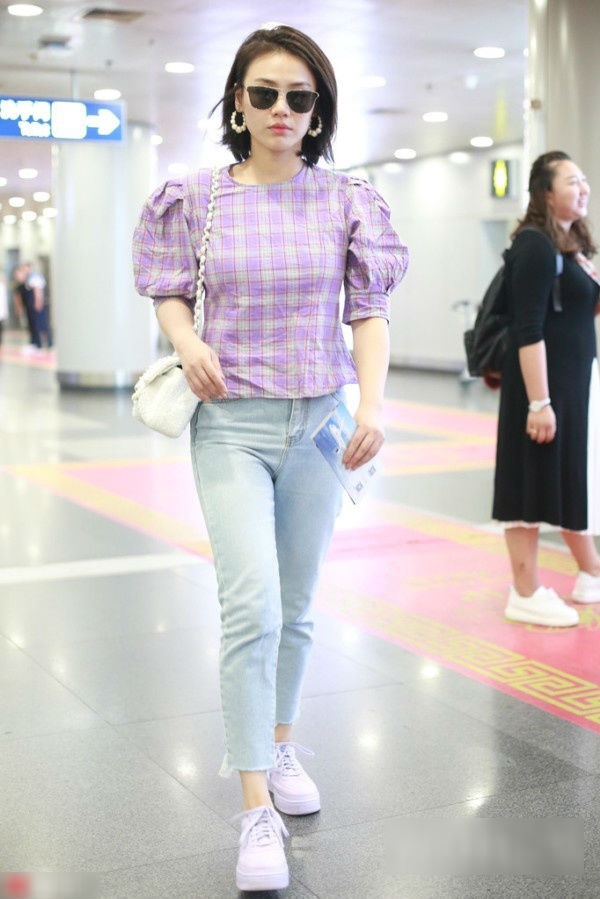 Nữ diễn viên Mã Tư Thuần kết hợp áo sơ mi kẻ sọc màu tím lavender với quần jeans, túi xách và giày sneaker vừa trẻ trung vừa năng động.    