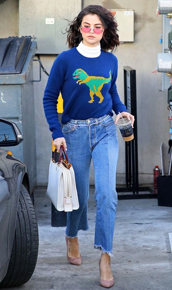 Xuống phố với áo len xanh in họa tiết khủng long ngộ nghĩnh, kết hợp cùng với quần jeans rách gấu đóng thùng, Selena vẫn cực kỳ nổi bật.