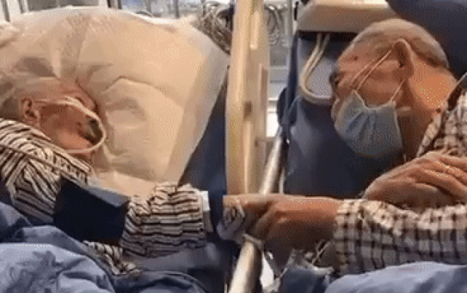 Lặng người cảnh cụ ông 80 tuổi nhiễm virus corona nắm chặt tay vợ trên giường bệnh