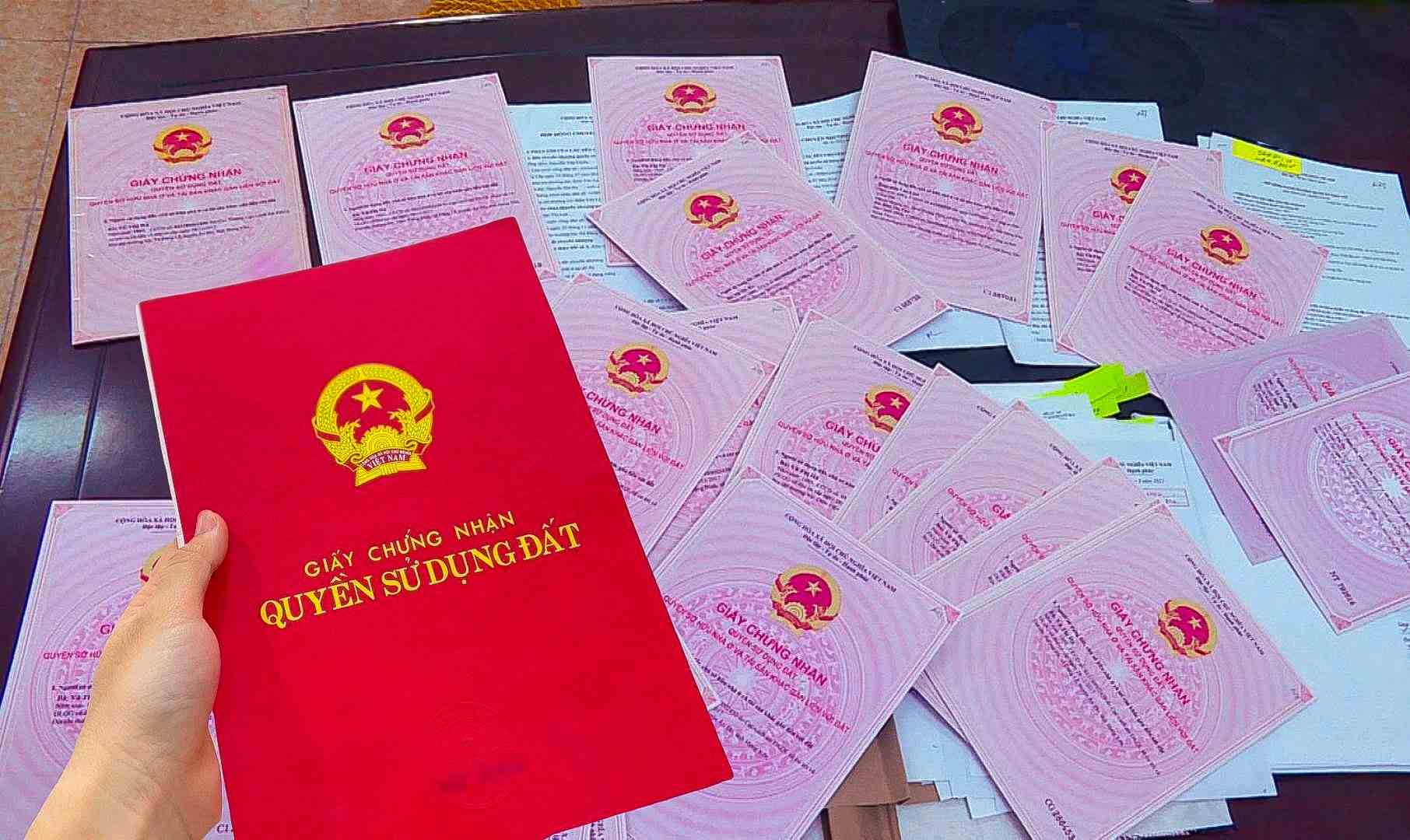 Các quy định mới của Luật Đất đai 2024 yêu cầu sổ đỏ thửa đất của một hộ gia đình ghi lại tên tất cả những người có chung quyền sử dụng đất. (Ảnh minh họa)