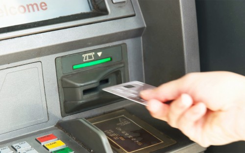 close-up-of-a-customer-inserting-a-card-into-an-atm-machine_r1h5fvm__f0003